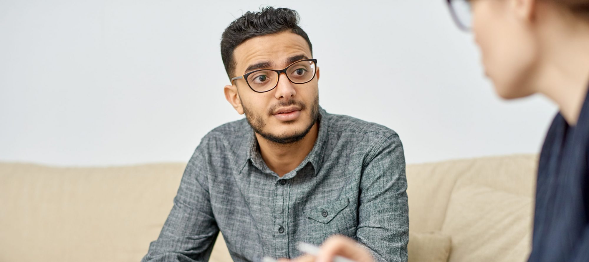 Young man having Productive Conversation with Psychologist